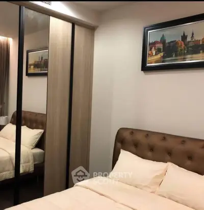 Cozy bedroom with mirrored wardrobe and elegant decor