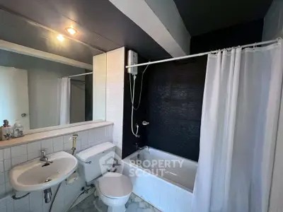 Modern bathroom with bathtub and sleek design in a contemporary apartment.