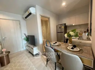 Modern open-plan living and dining area with stylish decor and air conditioning.