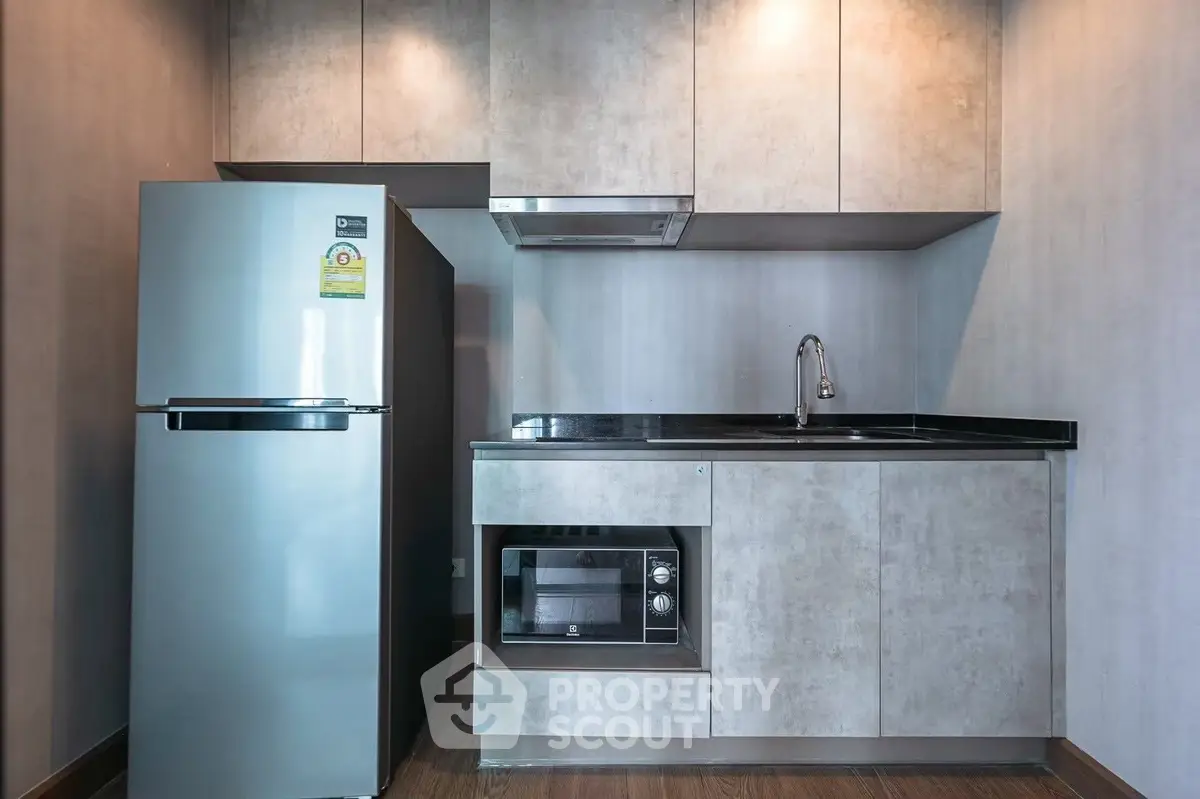 Modern compact kitchen with sleek appliances and minimalist design