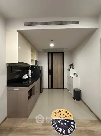 Modern kitchen with sleek cabinetry and appliances in a compact layout.