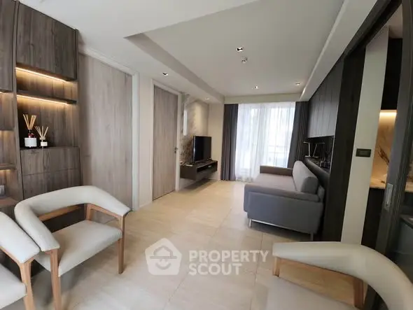 Modern living room with sleek furniture and natural light, perfect for relaxation and entertainment.