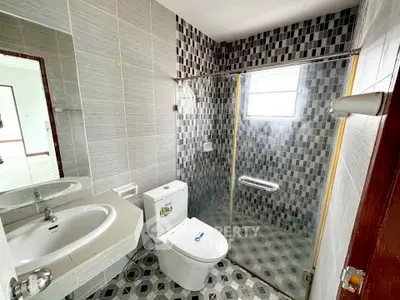 Modern bathroom with sleek tiles and glass shower enclosure
