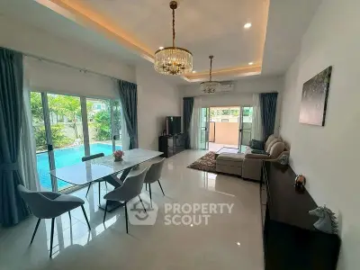 Luxurious living room with pool view, elegant dining area, and modern decor