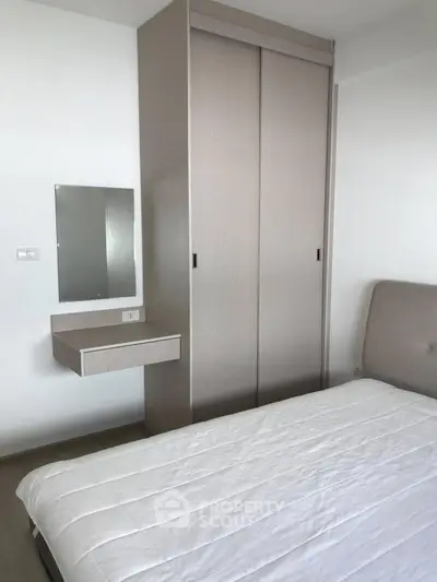 Modern minimalist bedroom with sleek wardrobe and cozy bed in a stylish apartment.