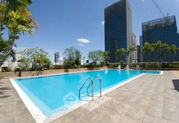 Luxurious rooftop pool with stunning cityscape views and lush greenery, perfect for relaxation and leisure.
