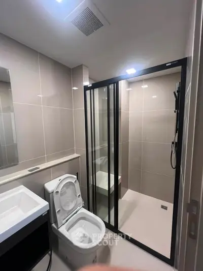 Modern bathroom with sleek shower enclosure and contemporary fixtures.