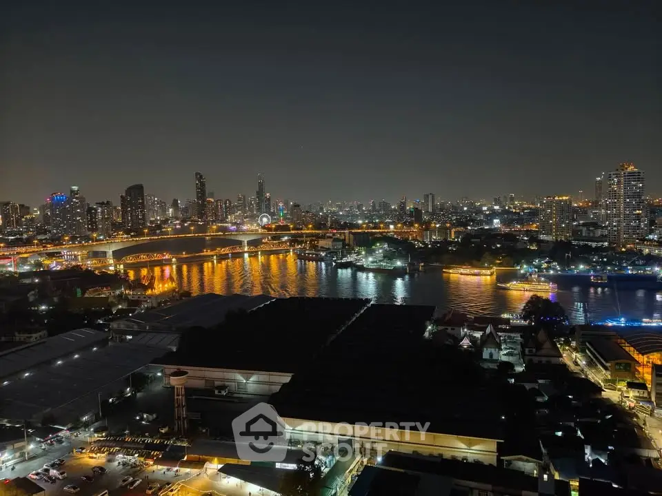 Stunning nighttime cityscape view with illuminated skyline and river reflections.