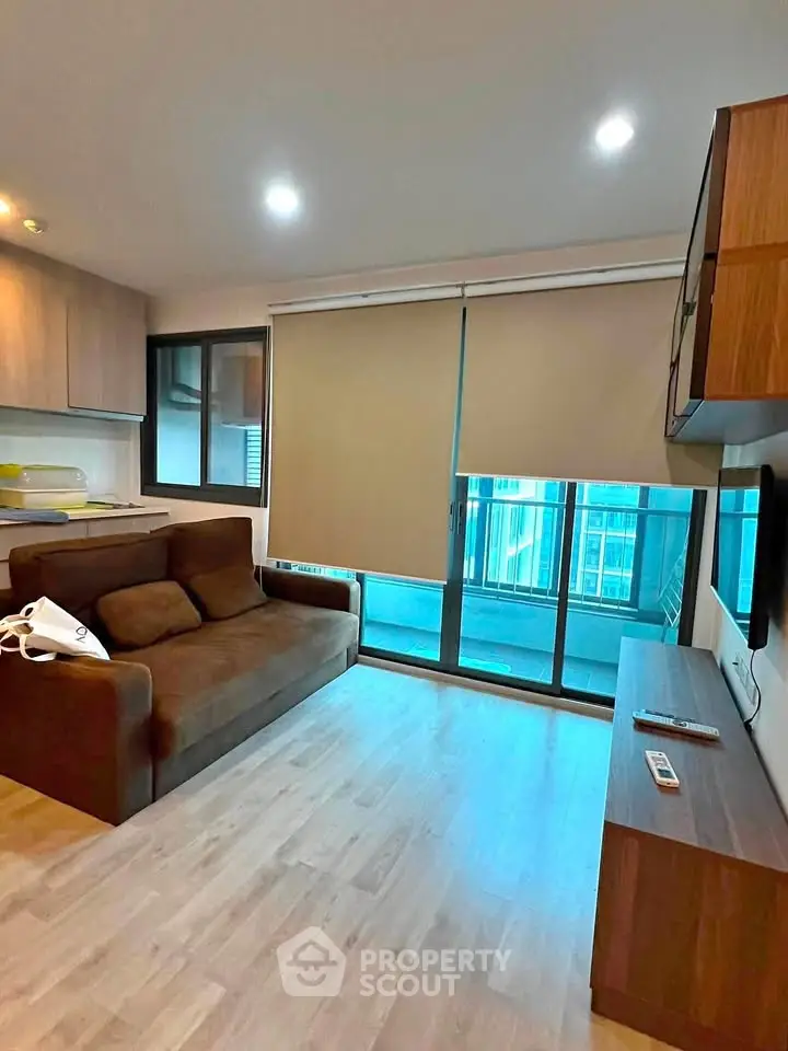 Modern living room with cozy sofa and balcony view in stylish apartment