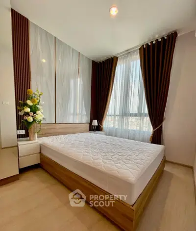 Modern bedroom with large window and elegant decor in a stylish apartment.