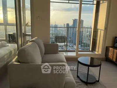 Chic living room with stunning city view and cozy balcony seating.
