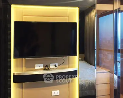 Modern bedroom with wall-mounted TV and city view, featuring sleek design and ambient lighting.