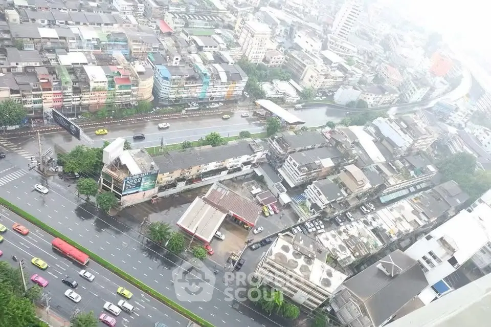 Aerial view of urban cityscape with roads and residential buildings on a rainy day.