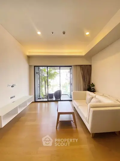 Spacious modern living room with large windows and elegant decor