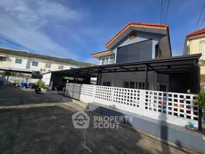 Modern two-story house with spacious driveway and contemporary design in a suburban neighborhood.