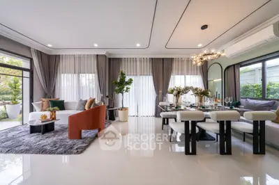 Luxurious open-plan living and dining area with modern decor and large windows.