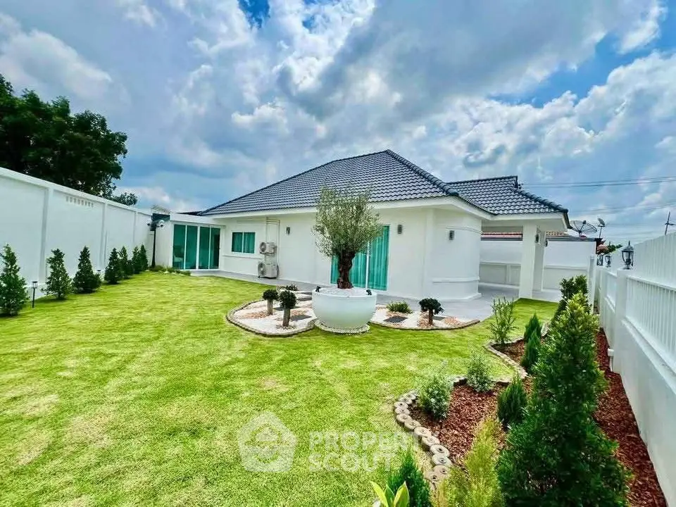 Charming single-story home with lush green garden and modern exterior design.