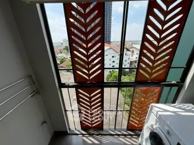 Modern apartment balcony with washing machine and city view
