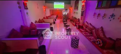 Chic lounge area with vibrant decor and cozy seating, perfect for social gatherings.