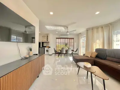 Spacious modern living room with sleek furniture and abundant natural light