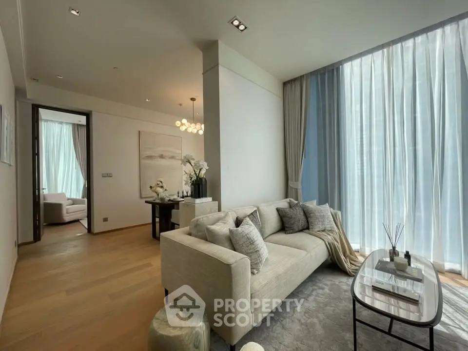 Luxurious living room with elegant decor and large windows offering natural light.