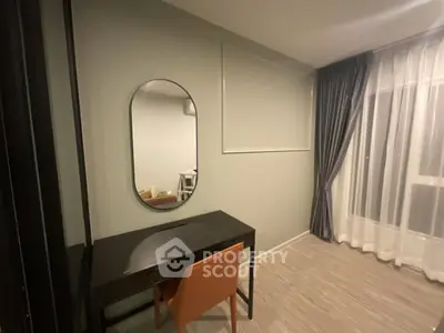 Modern study room with elegant desk and chair, featuring a stylish oval mirror and floor-to-ceiling curtains.