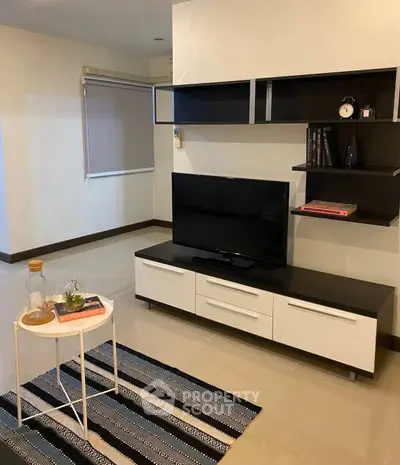 Modern living room with sleek TV stand and stylish shelving