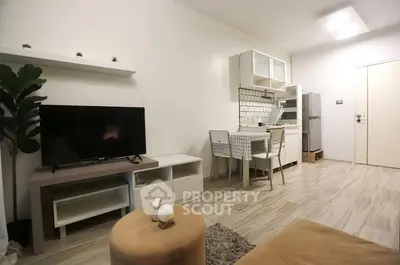 Modern minimalist living room with TV and compact kitchen area