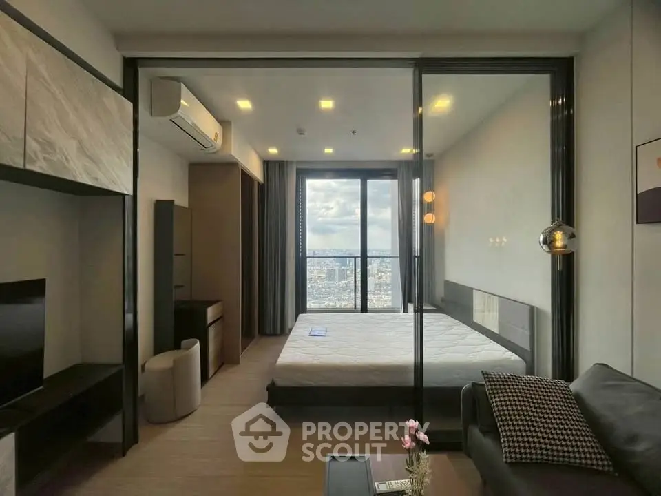 Modern bedroom with city view, featuring sleek design and large windows for natural light.