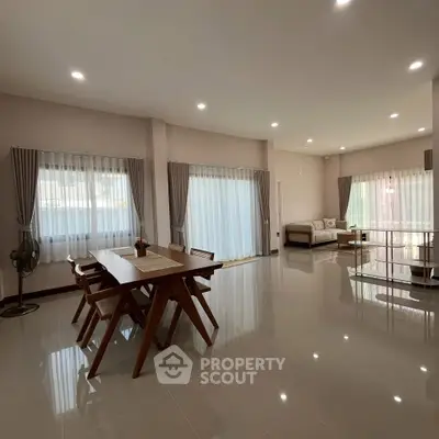 Spacious modern living room with elegant dining area and natural light