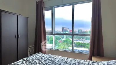 Cozy bedroom with city view from large window, featuring a wardrobe and stylish bedding.
