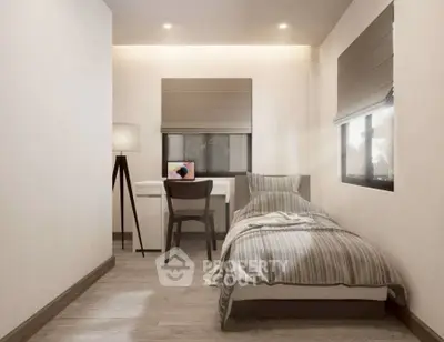 Cozy modern bedroom with single bed and study desk, perfect for minimalist living.