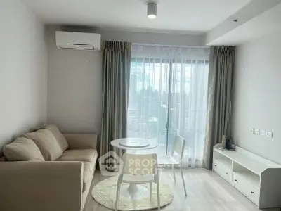 Modern living room with cozy sofa, dining table, and large window with city view.