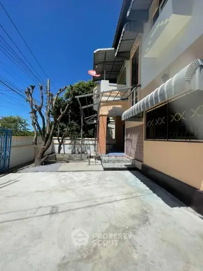 Charming two-story house with spacious driveway and unique architectural design.