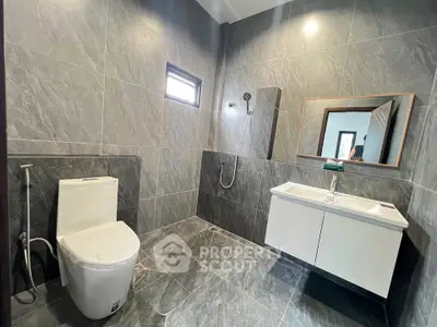 Modern bathroom with sleek gray tiles and contemporary fixtures