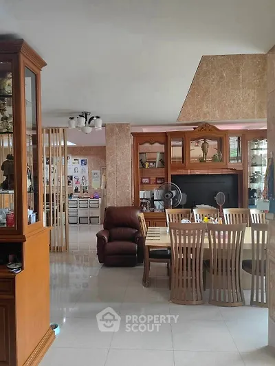 Spacious living room with elegant dining area and cozy seating, perfect for family gatherings.