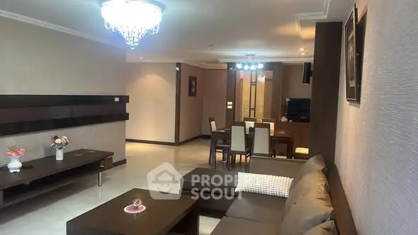 Spacious modern living room with elegant chandelier and dining area