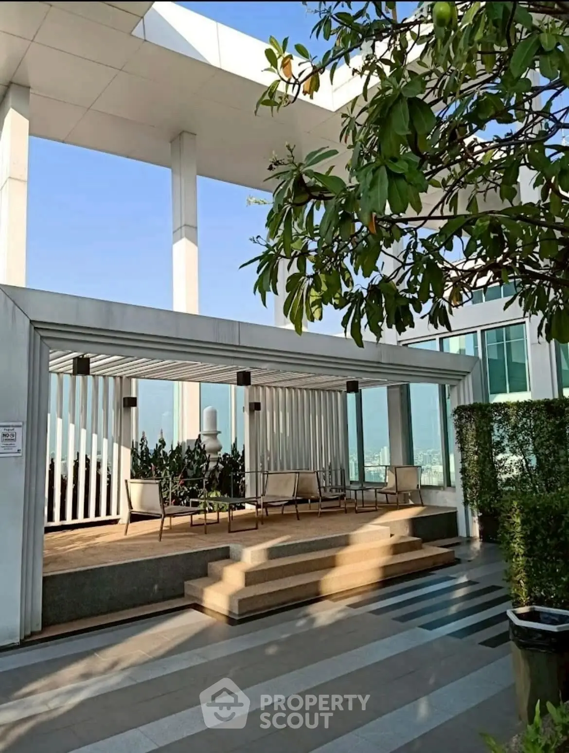 Luxurious rooftop terrace with modern seating and panoramic city views.