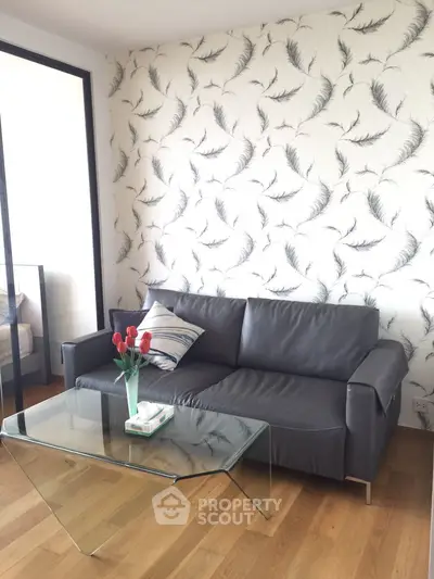 Modern living room with stylish wallpaper and sleek leather sofa
