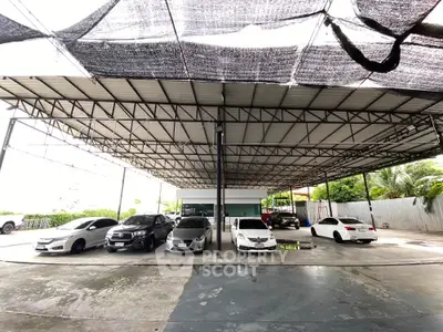 Spacious covered parking area with multiple cars in a modern facility