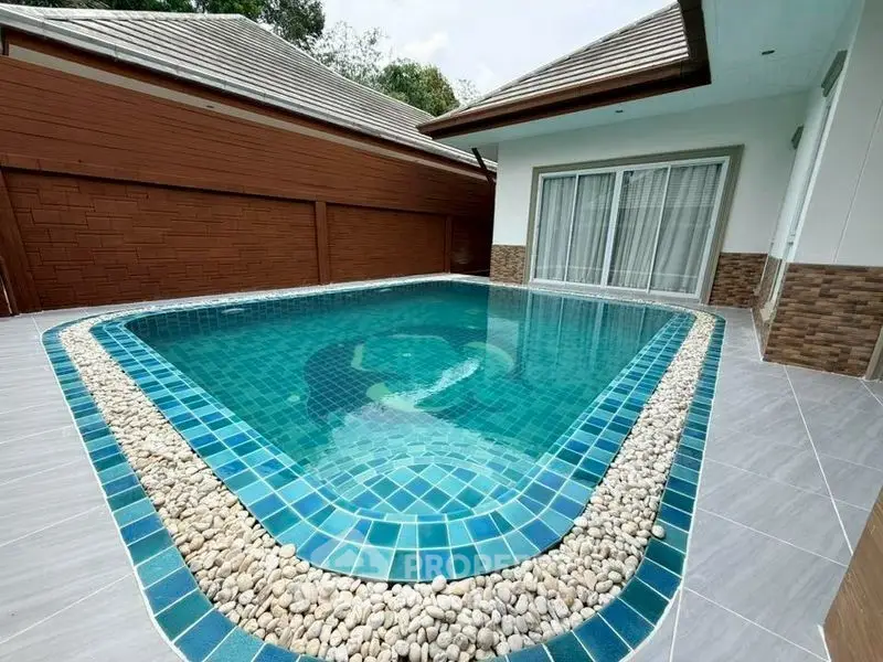 Luxurious private pool with modern design in a serene residential setting.