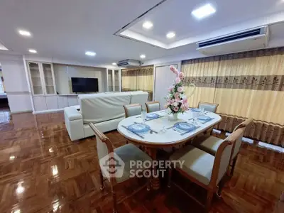 Spacious living and dining area with elegant decor and polished wooden floors.