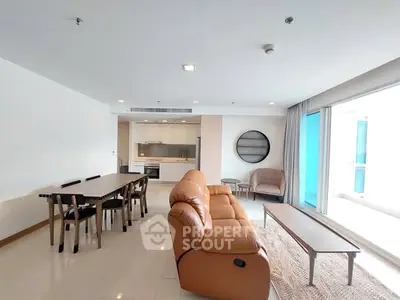 Spacious modern living room with open kitchen and elegant furnishings