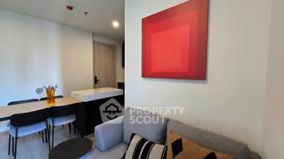 Modern living room with stylish decor and dining area in contemporary apartment.
