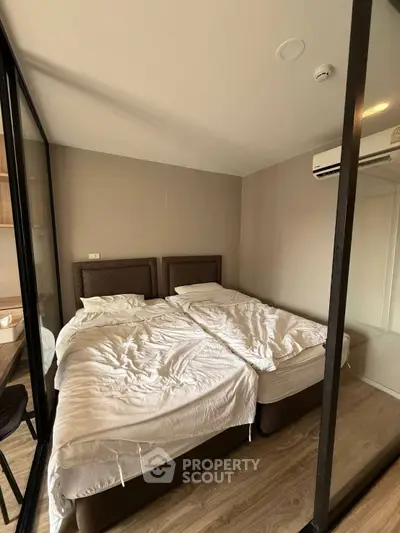Cozy bedroom with twin beds and modern air conditioning unit