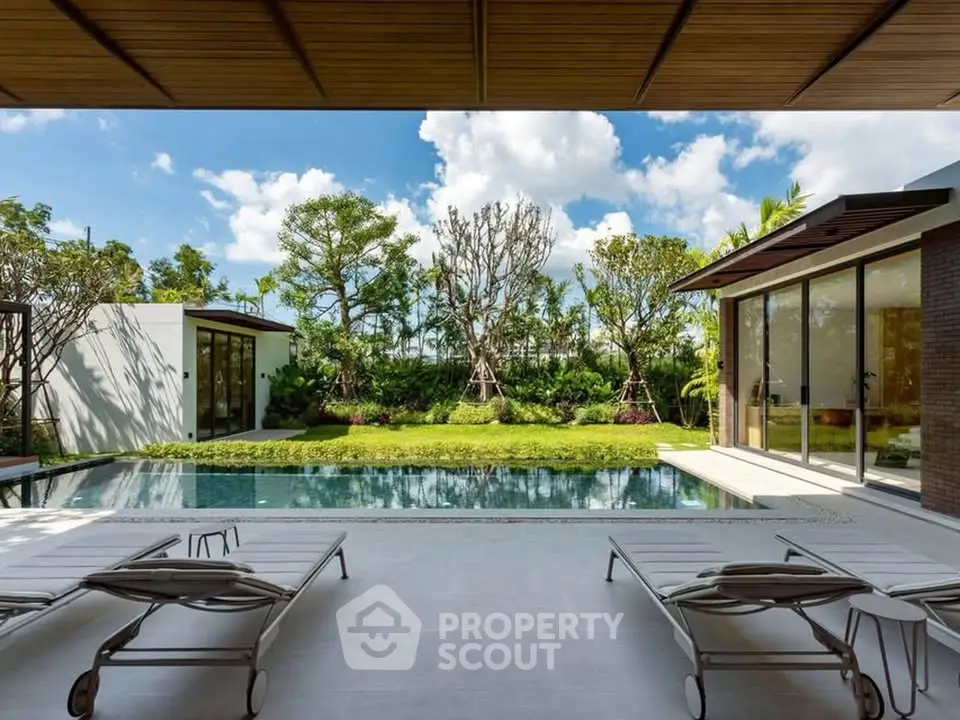 Luxurious modern villa with private pool and lush garden view, perfect for relaxation and leisure.