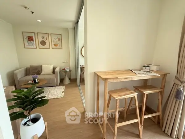 Stylish modern living room with cozy seating and wooden accents in a bright apartment.