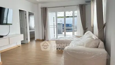 Spacious living room with modern decor and large windows for natural light