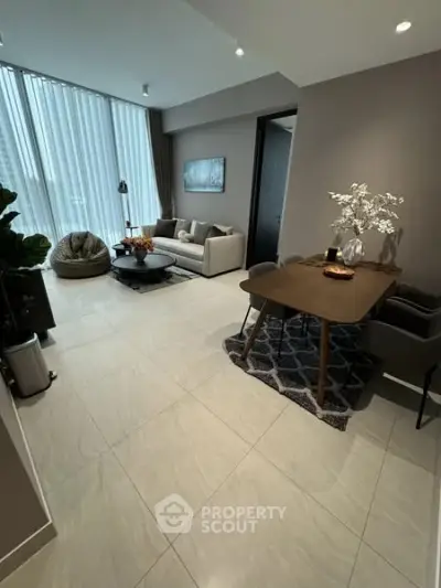 Modern living room with elegant decor and large windows in a stylish apartment.