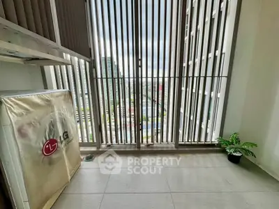 Modern balcony with city view and sleek vertical slats for privacy.